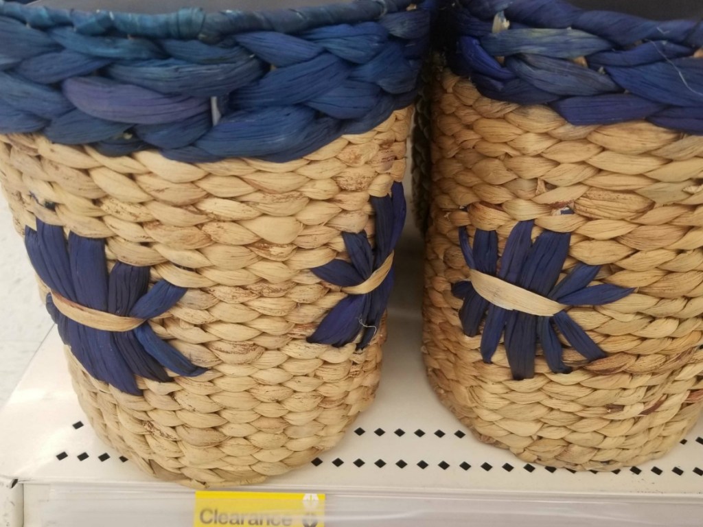 2 wicker blue and tan waste baskets on store shelf