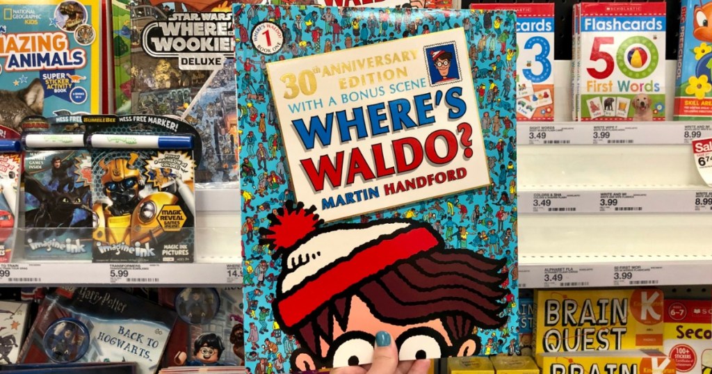 hand holding Where's Waldo book