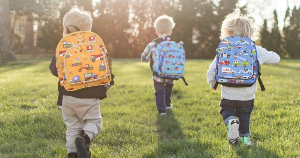 Toddler boys running in field wearing Wildkins Backpacks