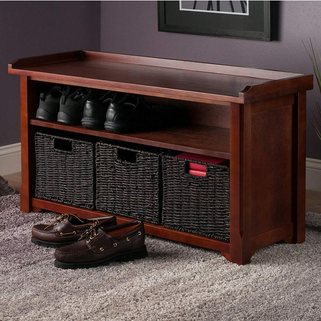 storage bench with shoes and baskets on it