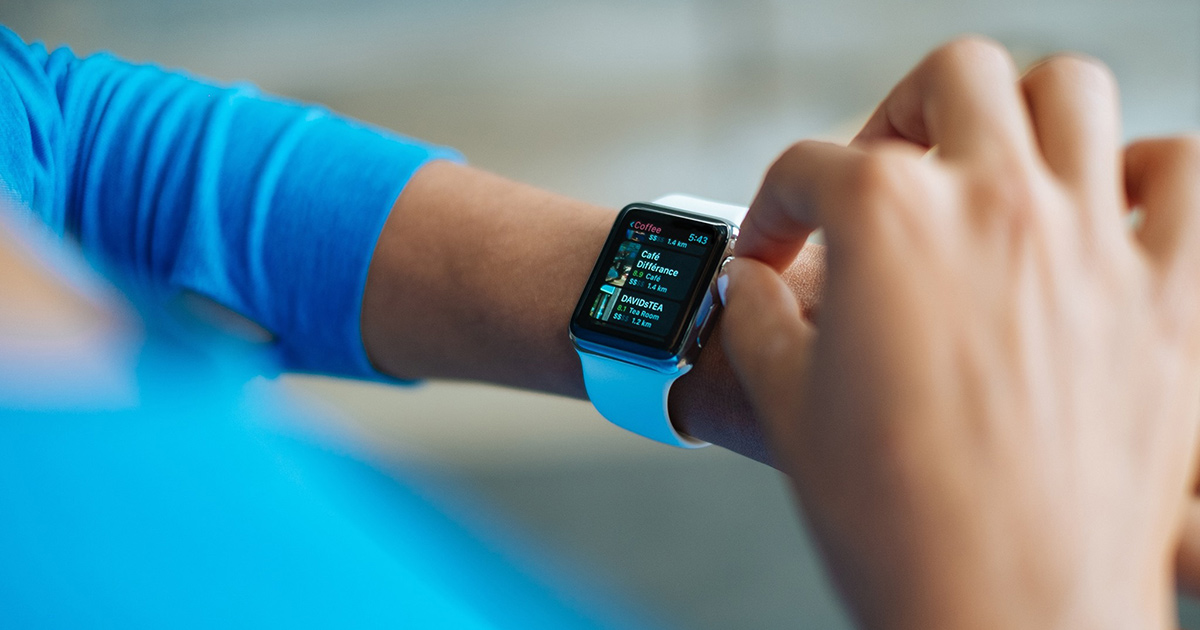woman wearing a smart watch using workout accountability app that pay you to work out