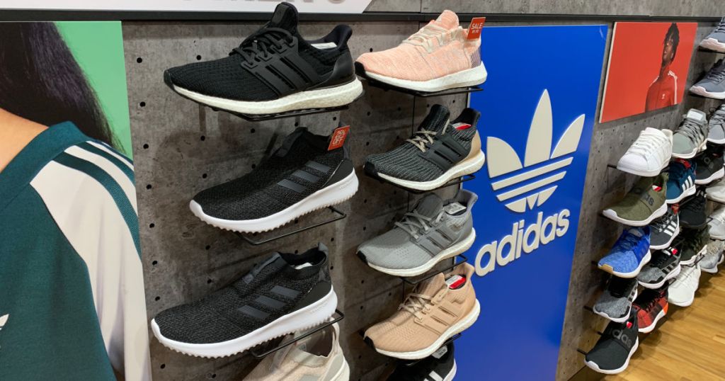 wall of adidas sneakers with adidas logo