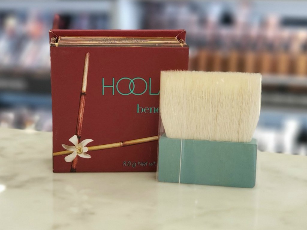 box of face powder and brush on store counter