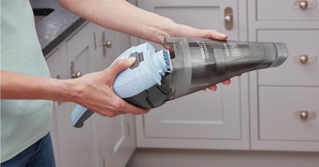 woman opening up black and decker ice blue handheld vacuum