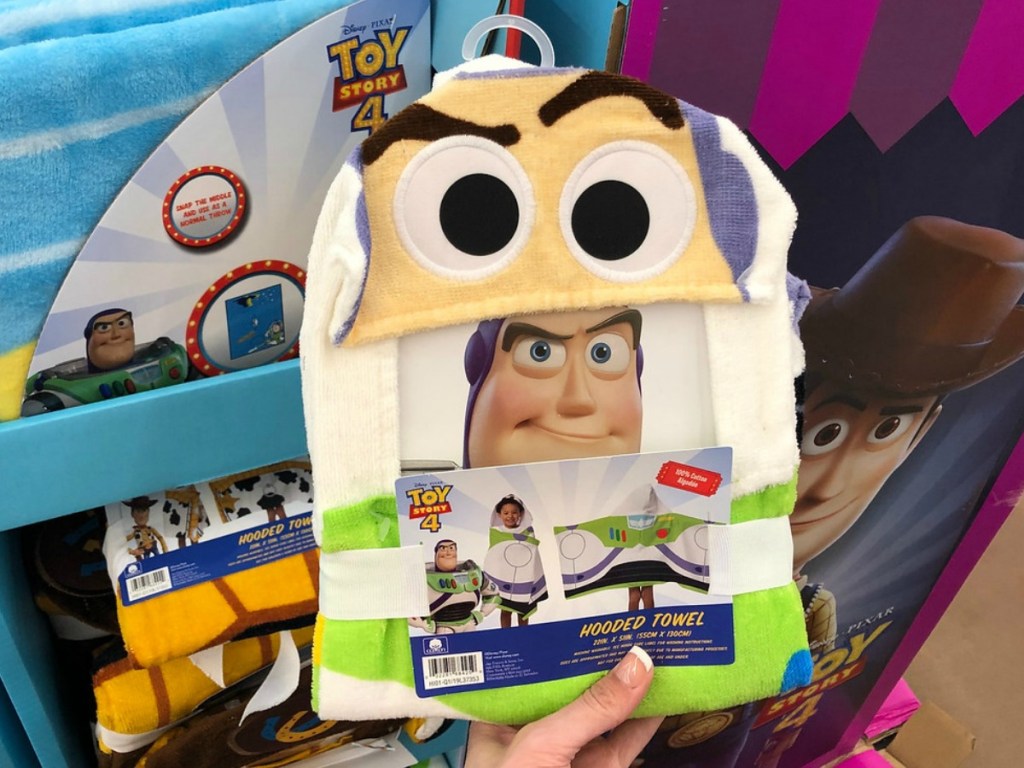 hand holding character towel with eyes by store display