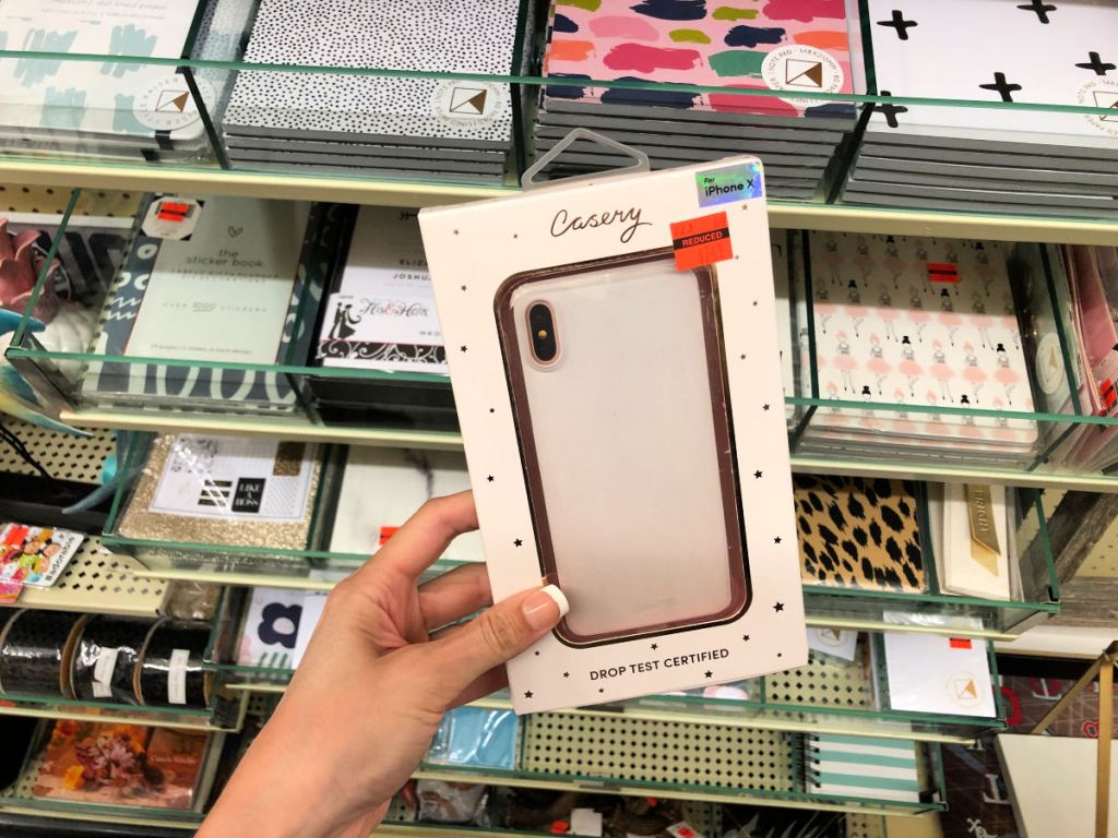 Woman holding casery iphone x rose gold case in hobby lobby