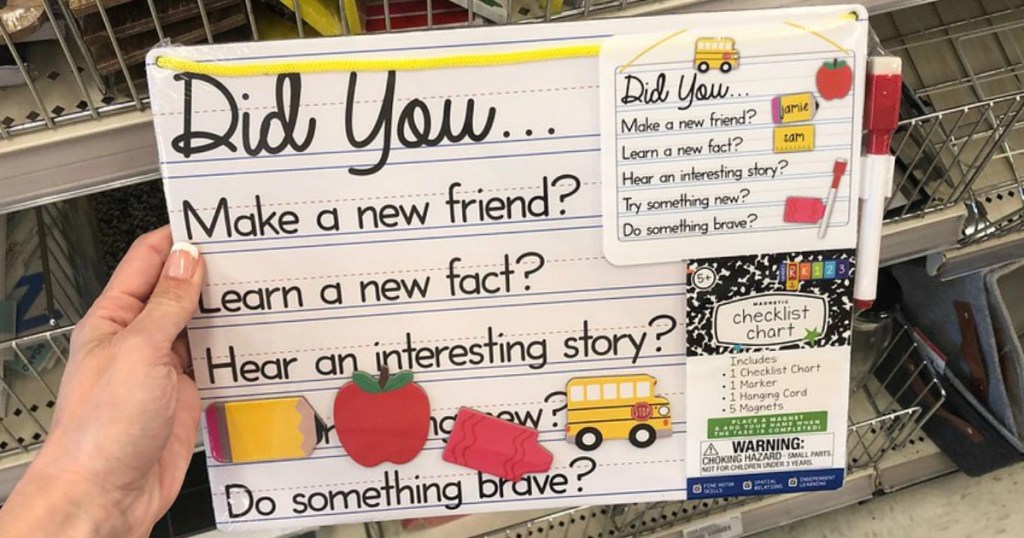 hand holding chart for kids to write in by store display
