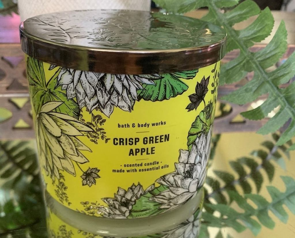 crisp green apple candle sitting on mirrored table