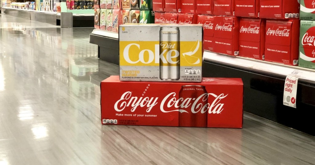 coca-cola 12-pack on store floor with diet coke twisted mango on top