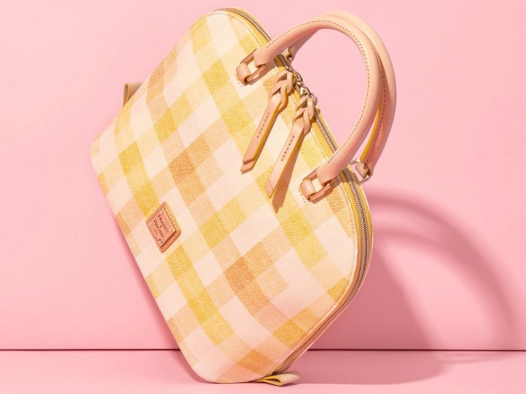 yellow and white checkered purse on pink background