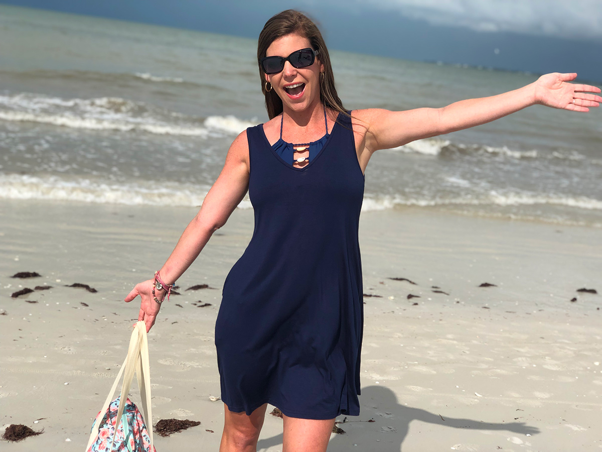 woman wearing swim cover up dress at the beach