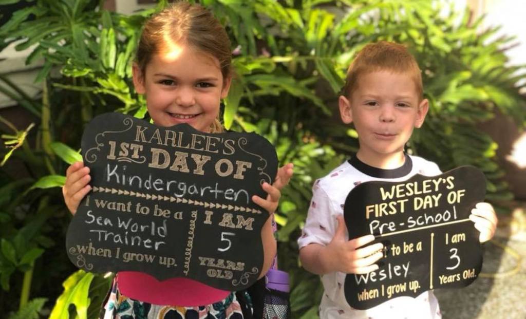 girl and boy ready for first day of school with chalkboards