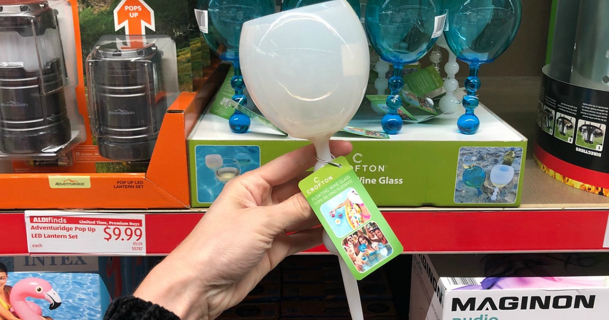 Woman holding white Crofton Floating Wine Glass in ALDi store