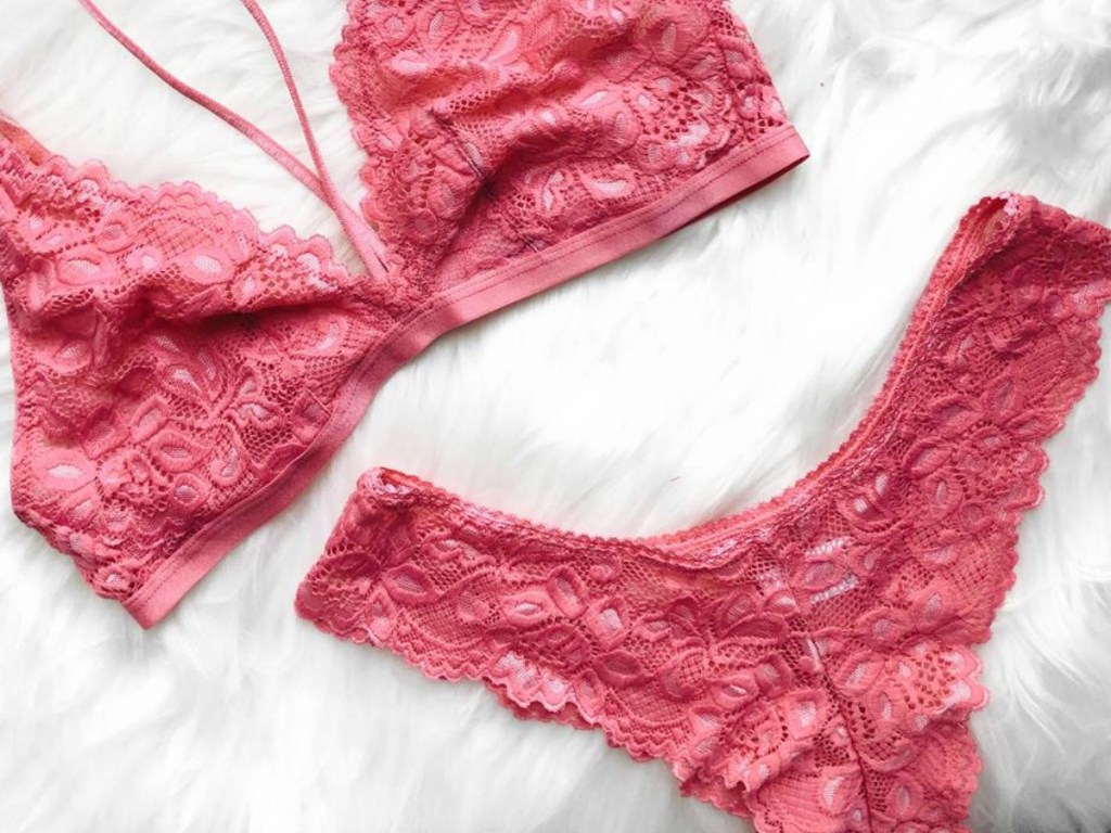 pink bra and panties on white blanket