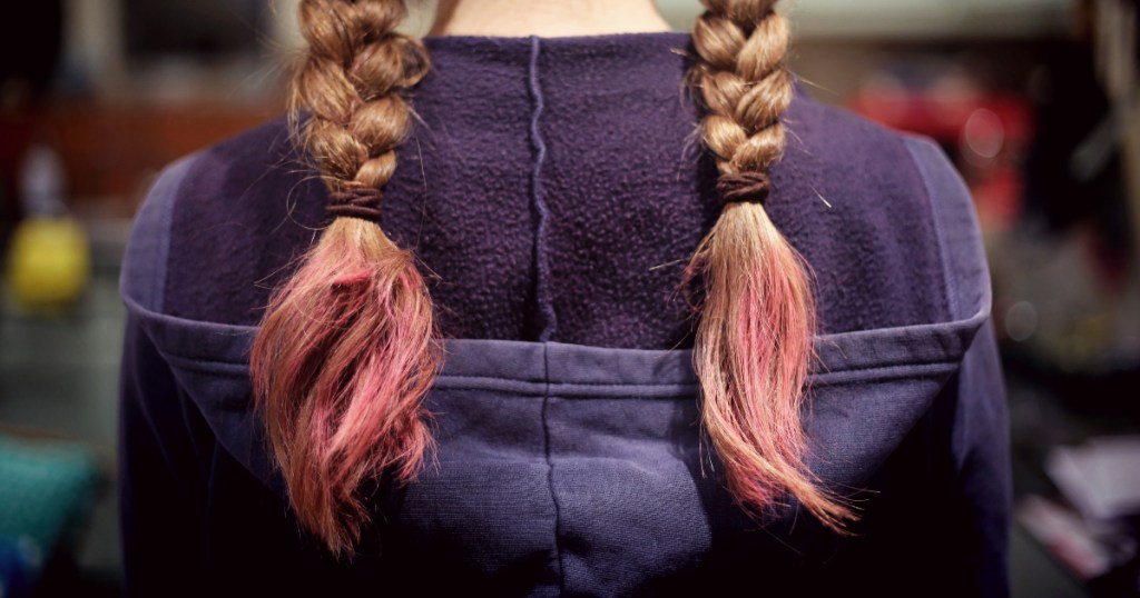 back of girl's head with braided hair in a navy hoodie