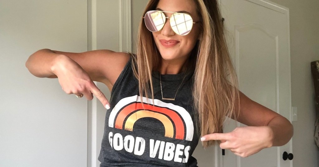 woman wearing good vibes rainbow tank with aviators