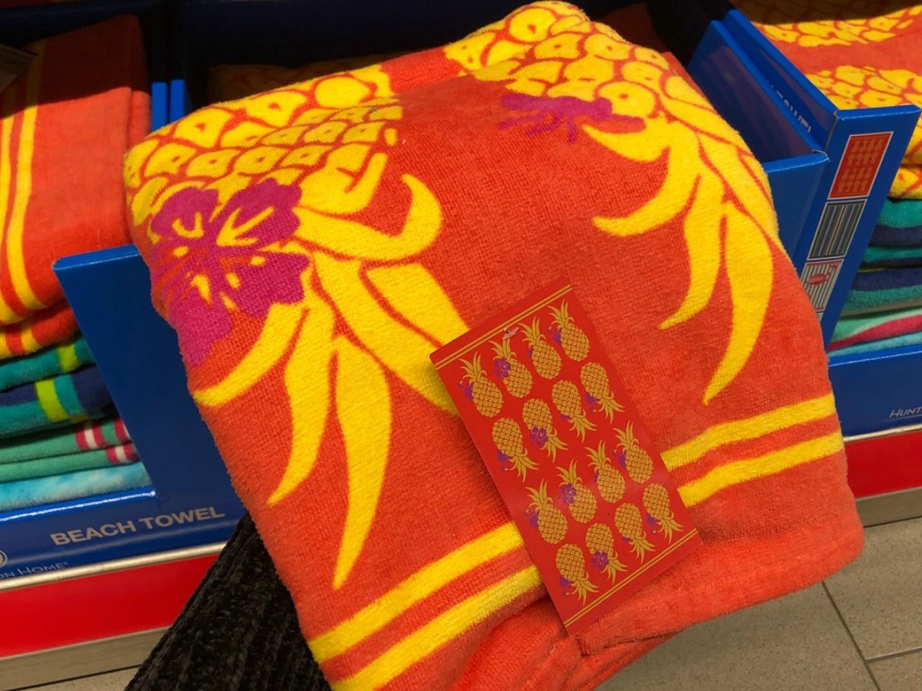 orange beach towel with pineapples on it