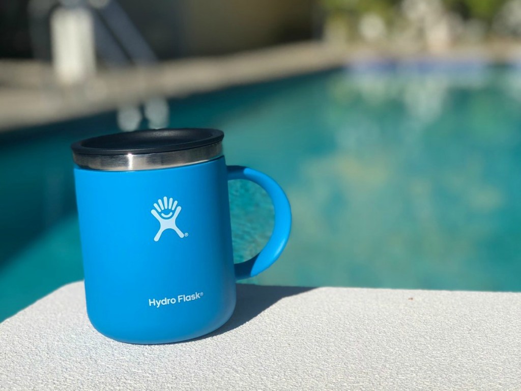 blue coffee mug outside by pool