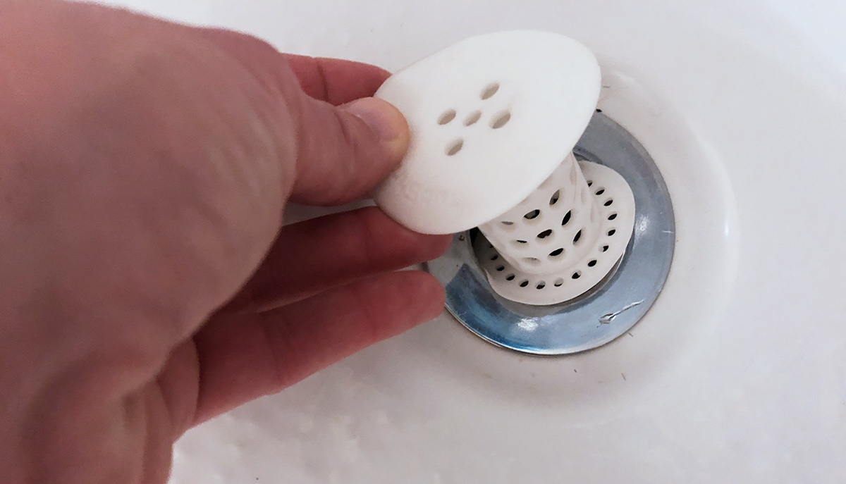 inserting tubshroom device into bath drain
