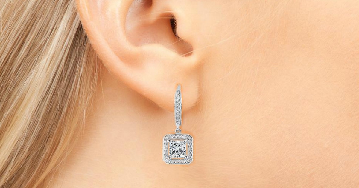 closeup of diamond square drop earrings on a woman's ear