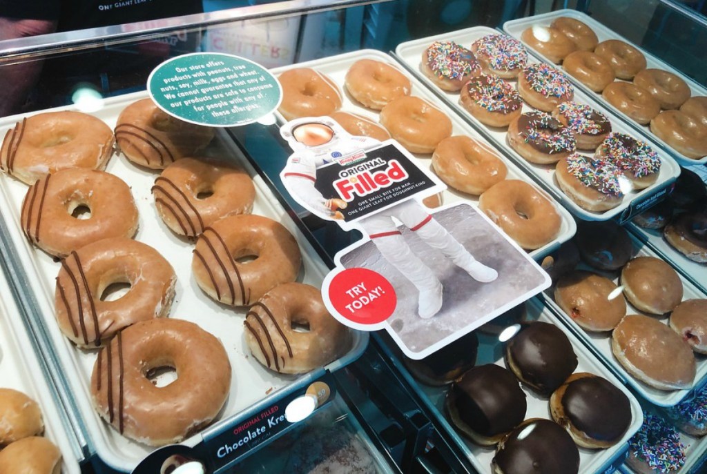 racks of Krispy Kreme doughnuts in store