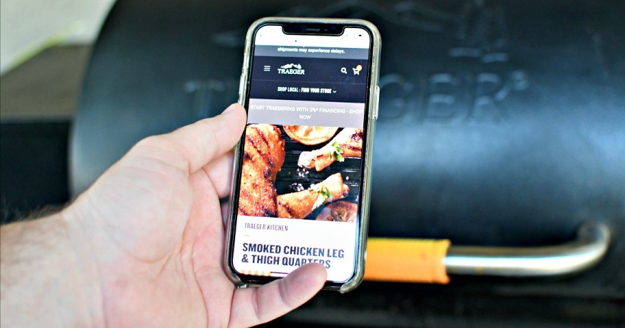 man holding the traeger app