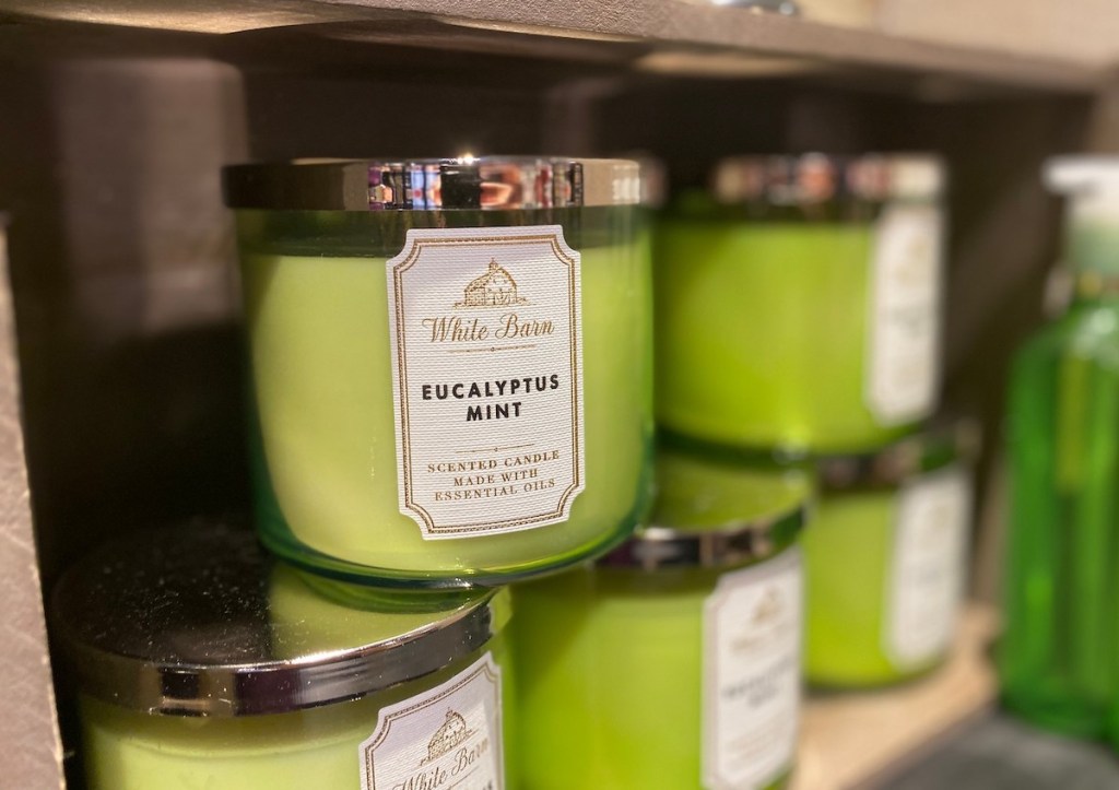 stack of green candles on store shelf 