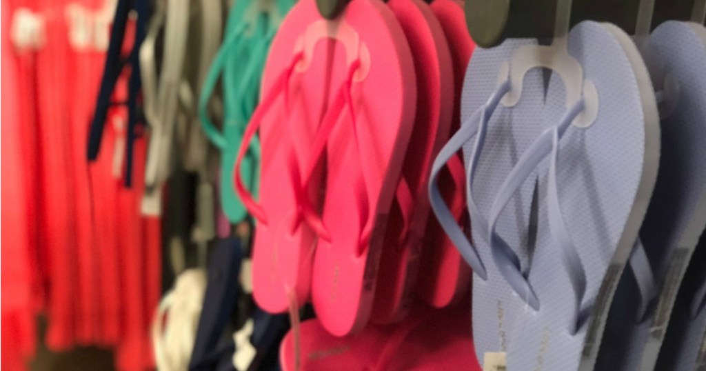 various colors of flip flops hanging in store