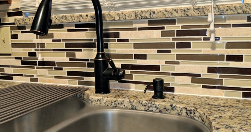 kitchen sink with tile on backsplash