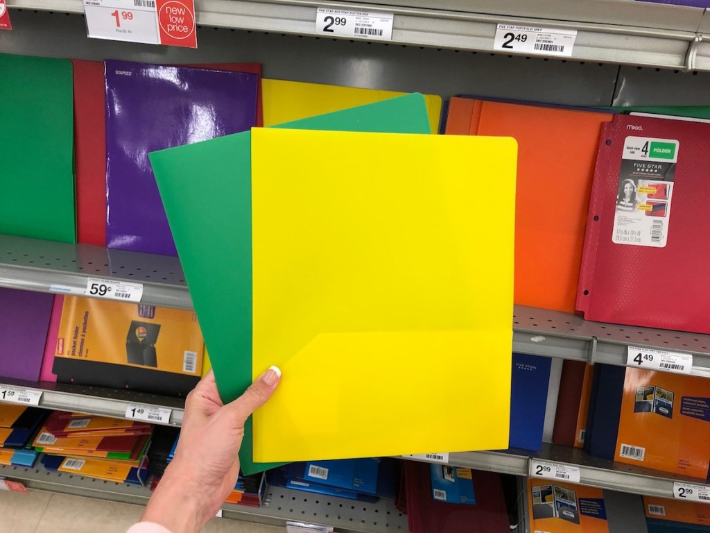 hand holding yellow and green poly folder