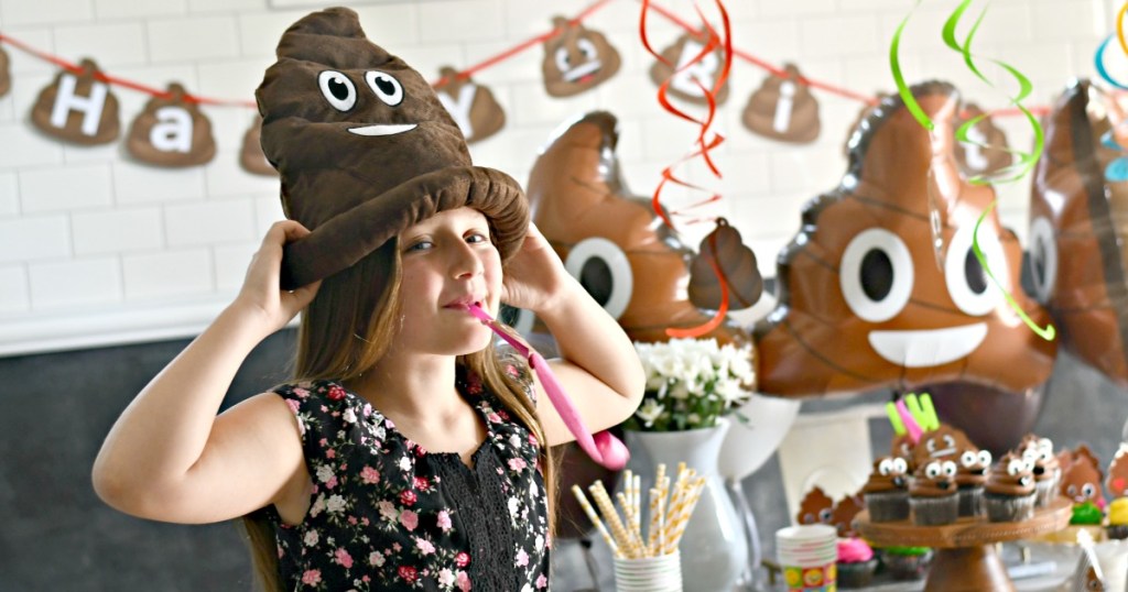 girl with poop emoji hat on at poop themed party 