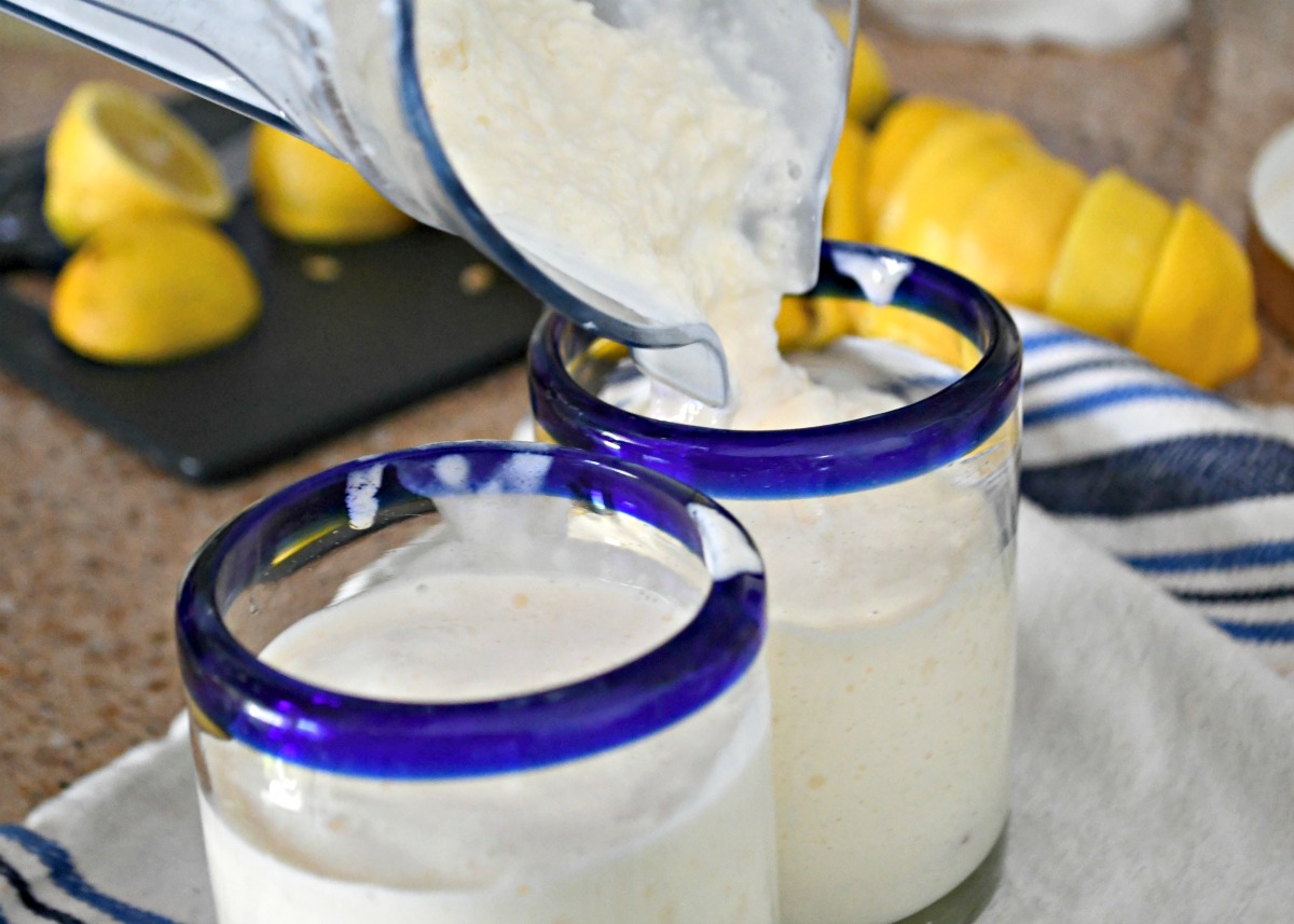 pouring creamy frosted lemonade into glasses