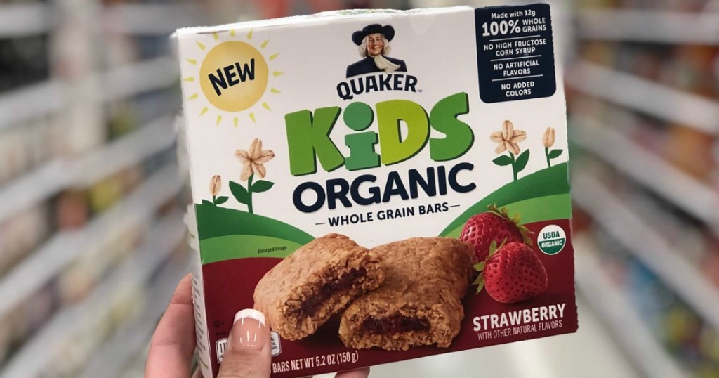 hand holding box of kids snack bars in store