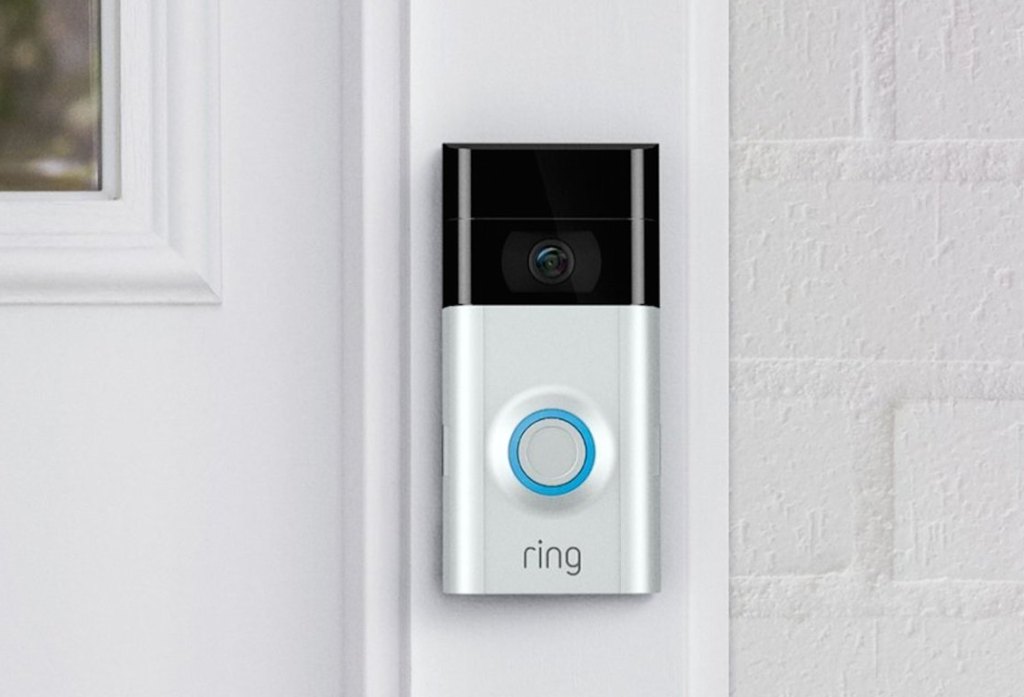 hand holding a ring doorbell in blue box in store