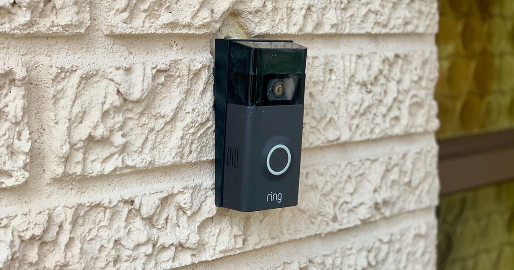 black ring doorbell on white brick house