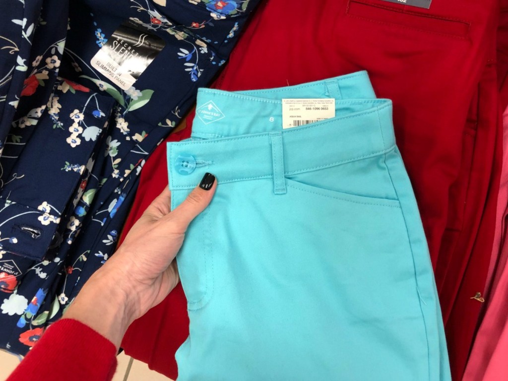 teal blue women's pants on a table of more pants