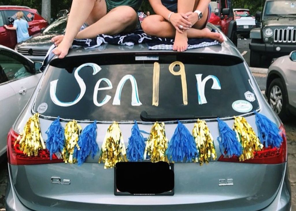 silver car decorate with banner and senior