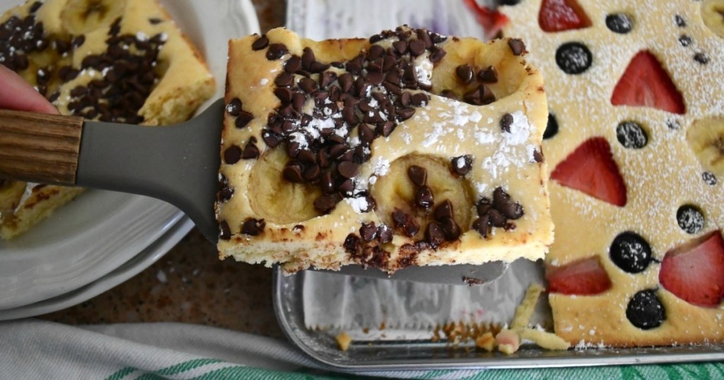 spatula scooping out sheet pan pancakes with chocolate chips 