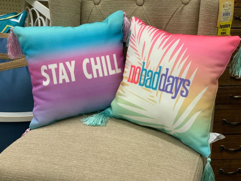 two colorful pillows on a chair