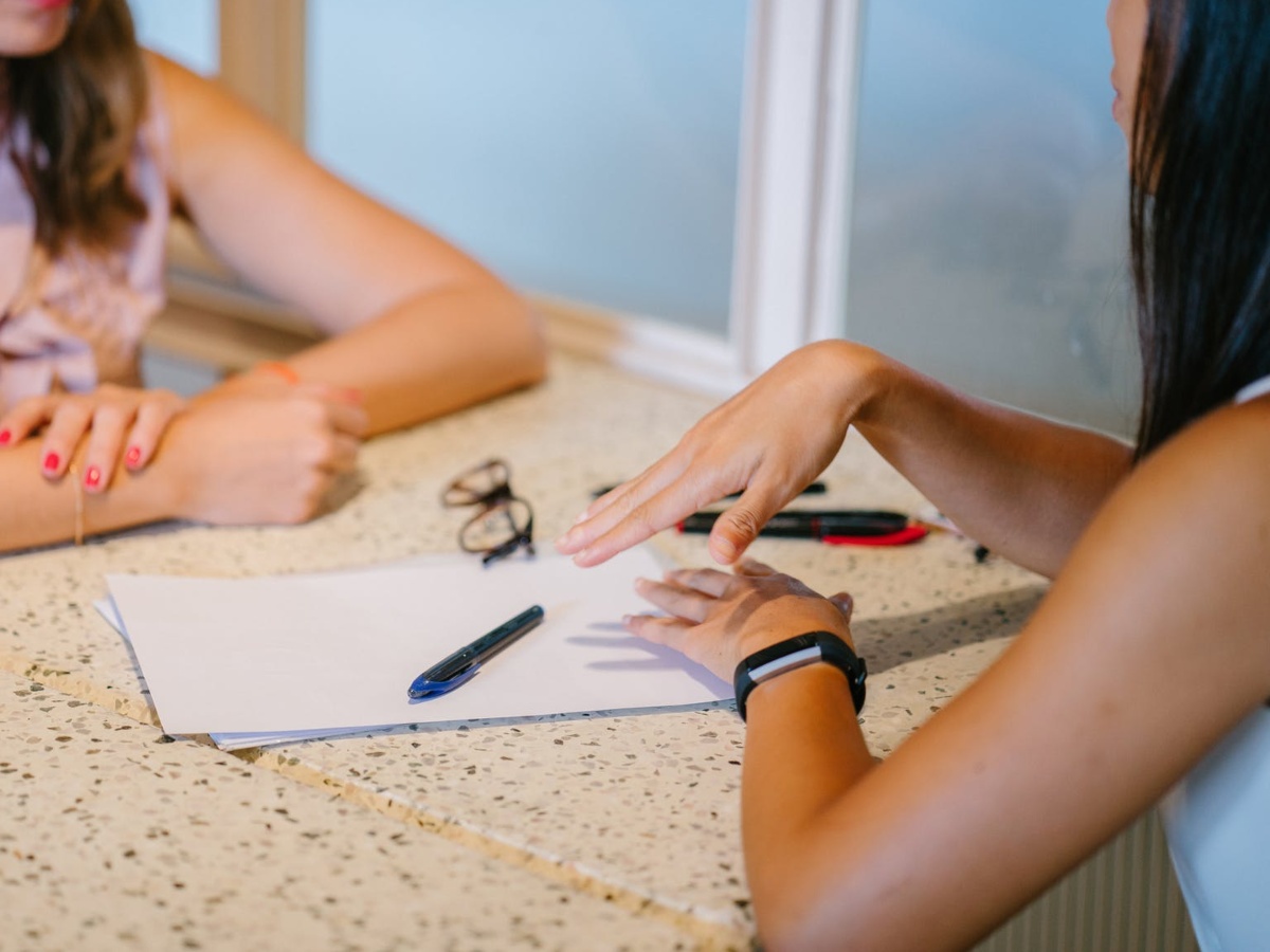 babysitting rates teenager at a job interview with papers on table