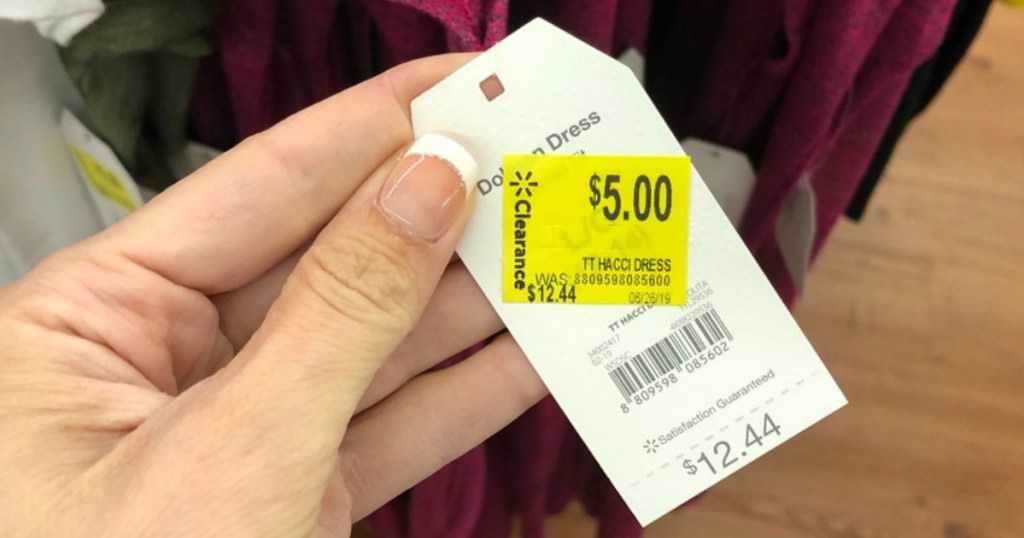 hand holding marked down price tag at walmart