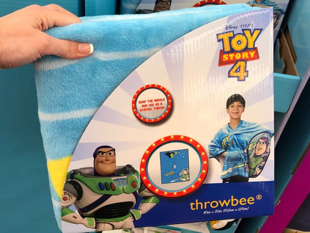 hand holding kids towl in front of store display