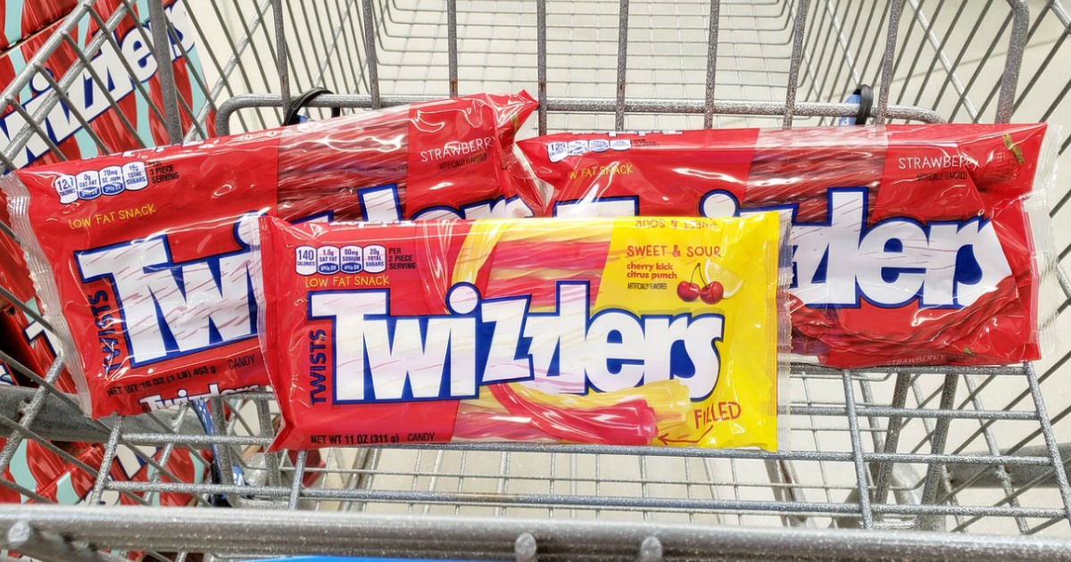 three bags of twizzlers candy in grocery cart