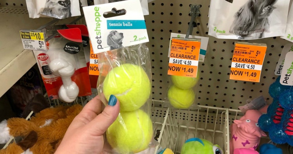 hand holding petshoppe tennis balls dog toys at walgreens