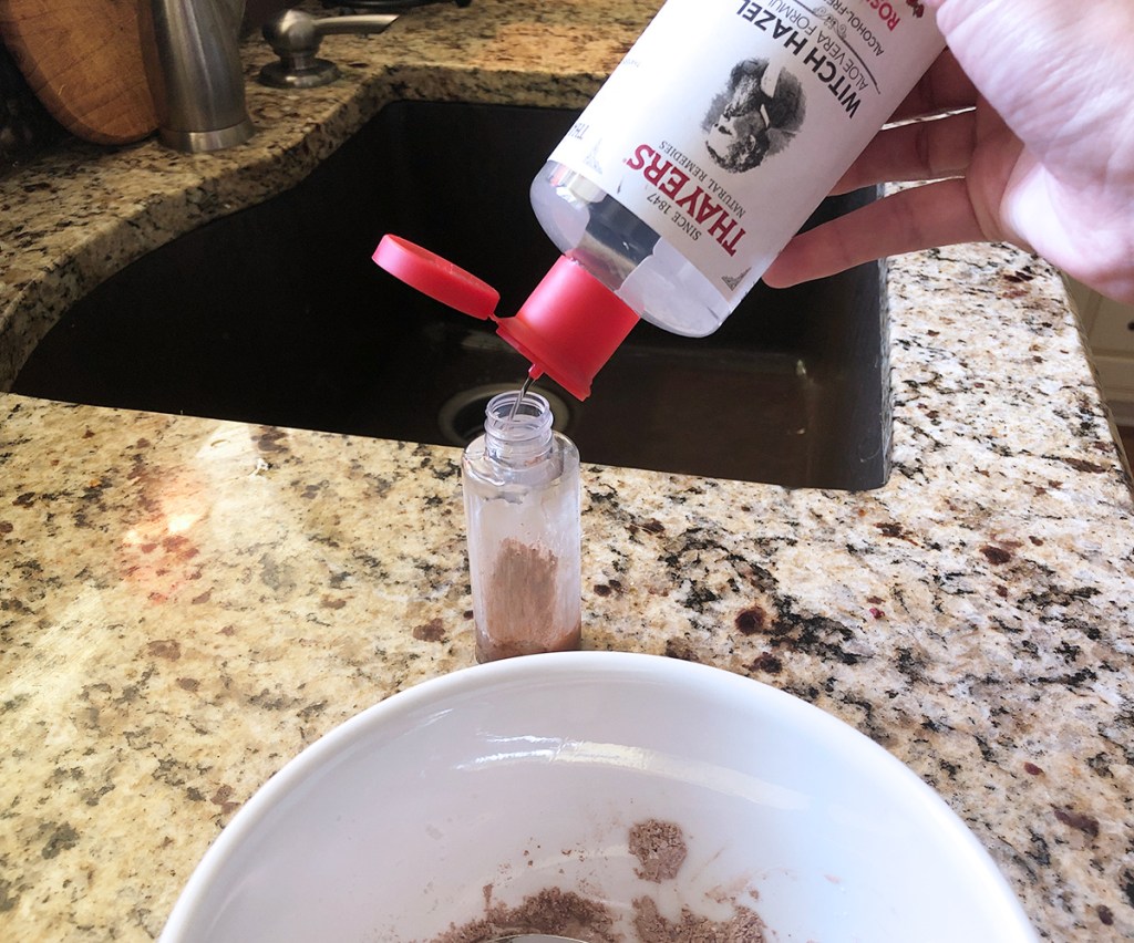 adding witch hazel and dry shampoo powder to spray bottle