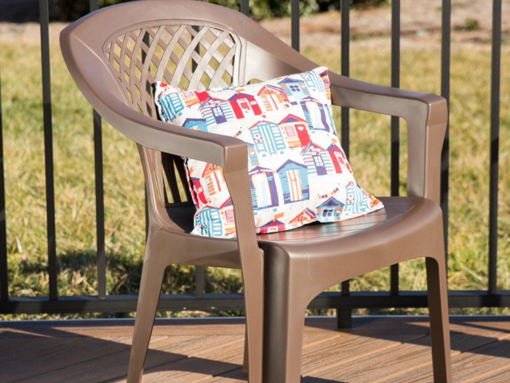 plastic chair on patio with pillow on it