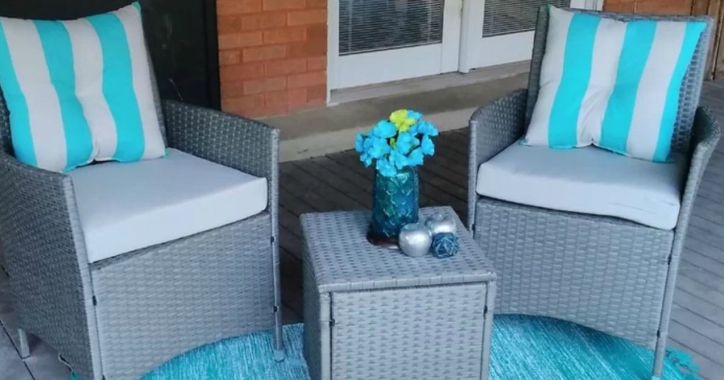 2 gray chirs with small table outside on porch