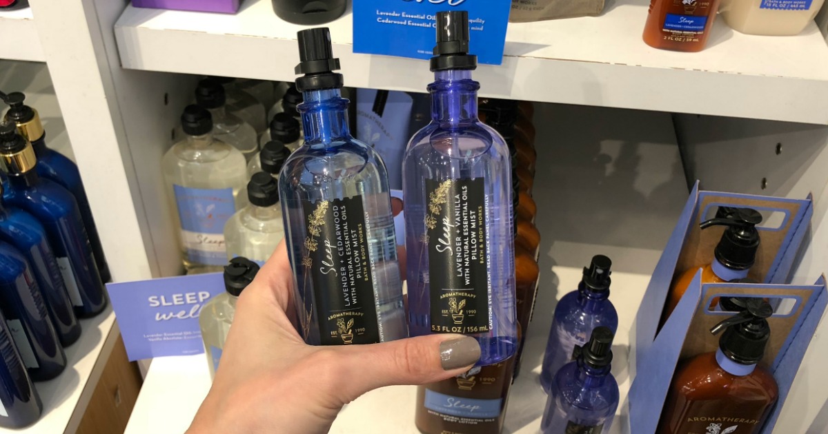 Woman holding bottles of Bath & Body Works Sleep Aromatherapy