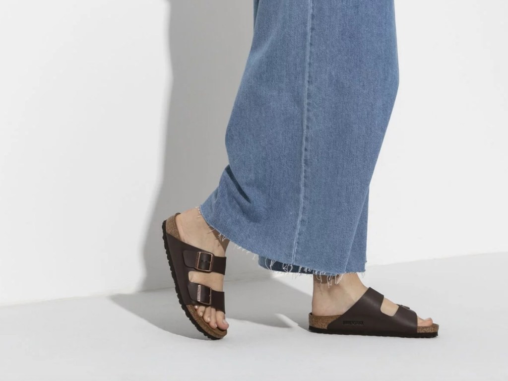 woman in denim skirt wearing Birkenstock Arizona Sandals