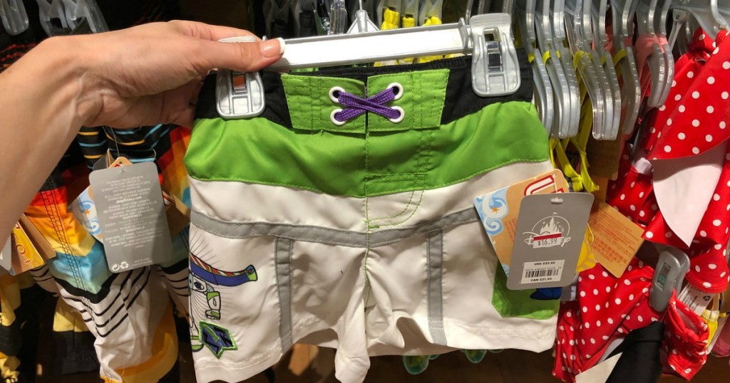 woman holding boys Buzz Lightyear swim trunks